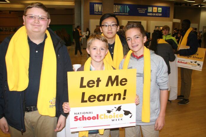 Students and adults sport yellow School Choice Week scarves