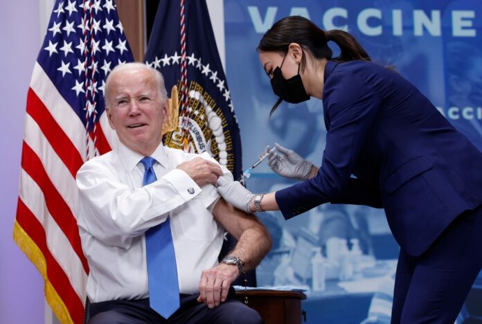 President Joe Biden receives a COVID-19 booster jab.