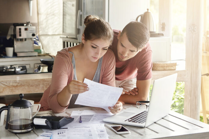 Couple managing finances, doing taxes