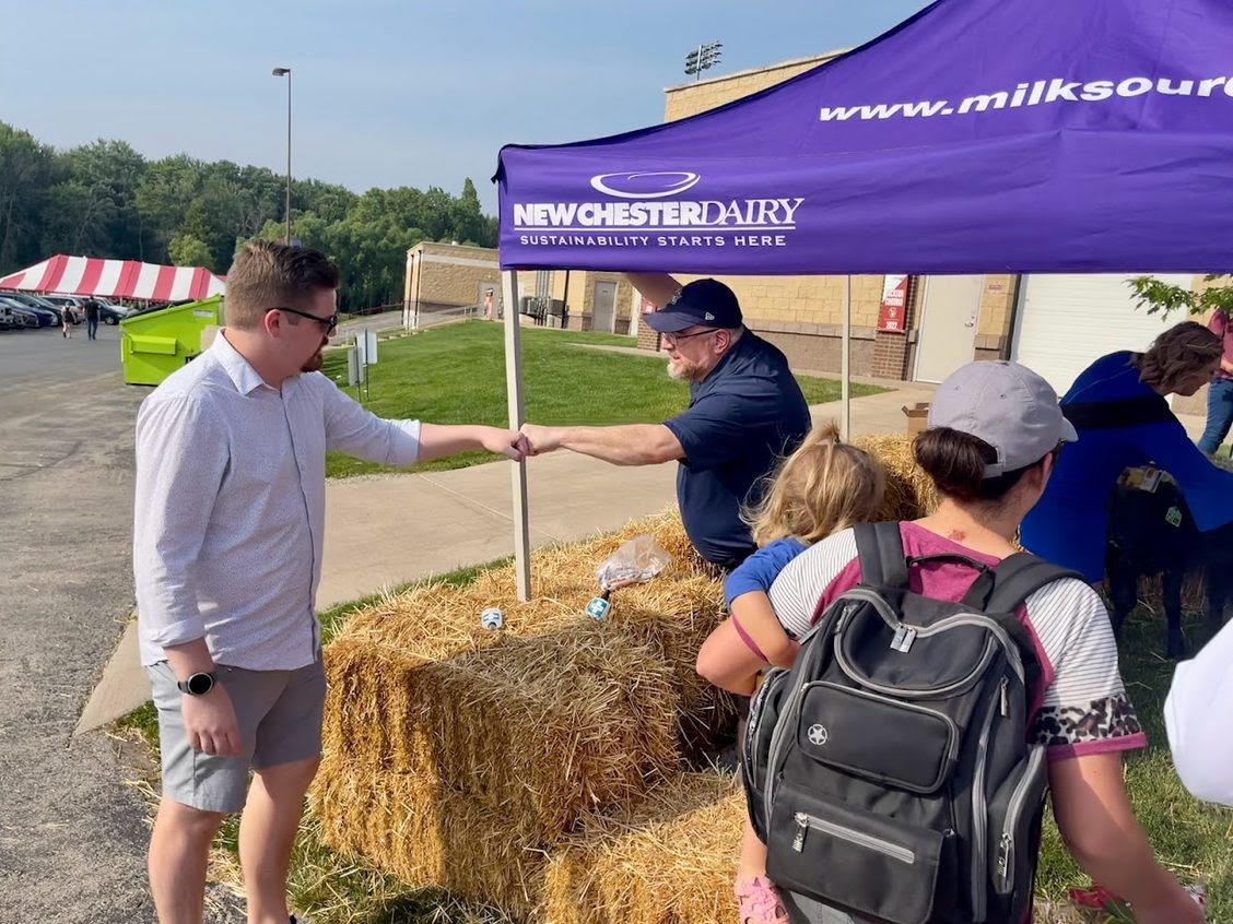 State Rep. Nate Gustafson visits the Newchester Dairy tent.