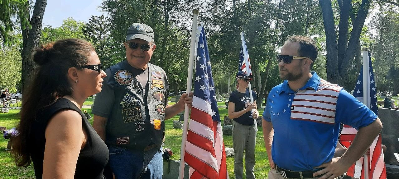 Sen. Rachael Cabral-Guevara joins Representative Ron Tusler (R- Harrison) and a veteran at the Memorial Day Service on May 29, 2023.