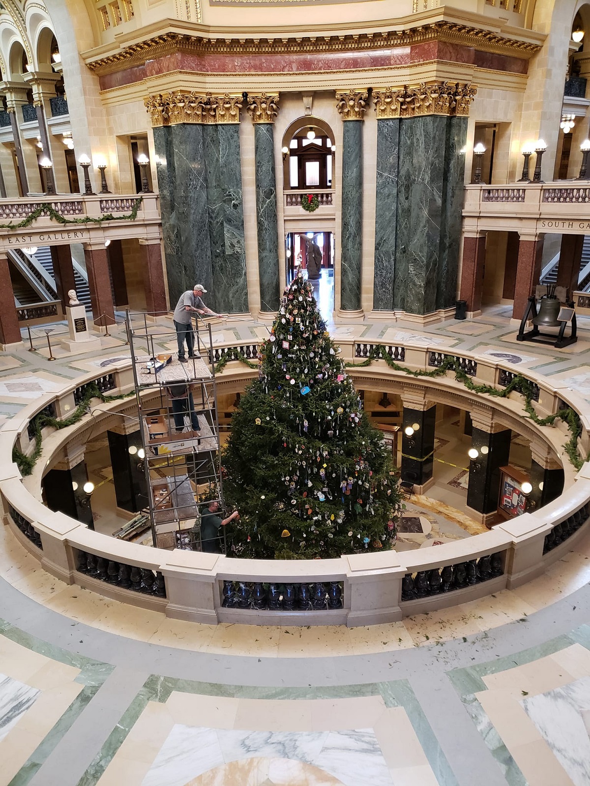 A scaffold tower allows workers to safely place the Christmas ornaments on the tree. Long poles are used to hang the ornaments which were handmade by Wisconsin elementary school students.