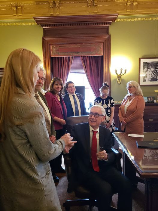 Rep. Goeben receiving a signatory pen from Gov. Evers.