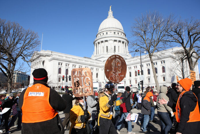 Opponents of Wisconsin Act 10 march on the capitol square on February 19, 2011 in Madison, Wisconsin. Editorial credit: Suzanne Tucker / Shutterstock.com