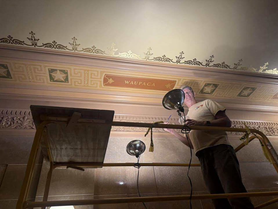 Capitol maintenance restoring the ceiling stenciling for Outagamie and Waupaca counties.