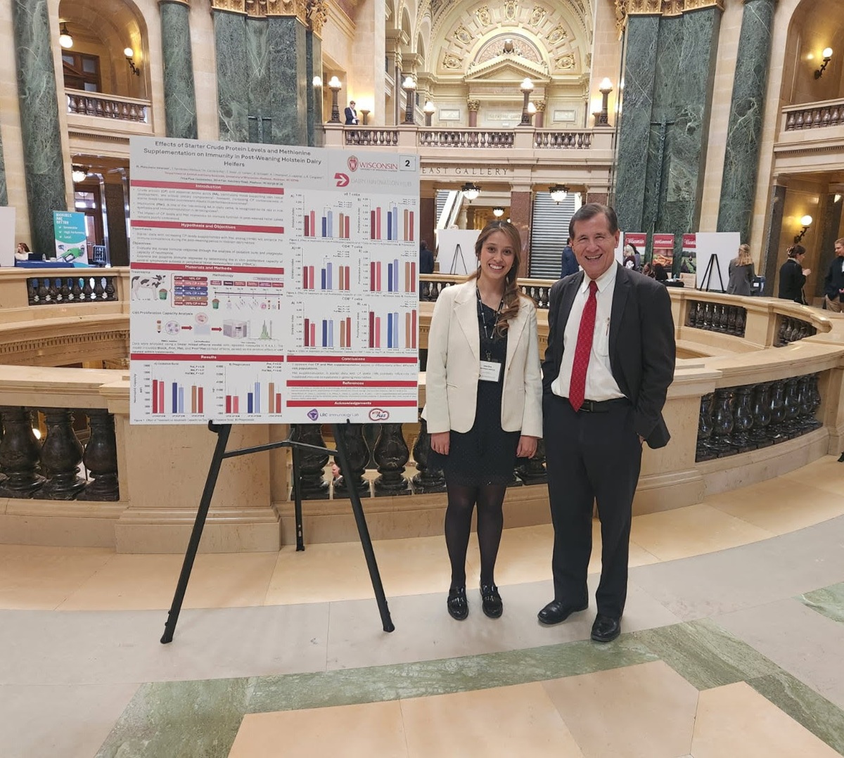 Wisconsin State Rep. Dave Murphy talks with Maria from UW-River Falls about new research she's participating in. The Dairy Innovation Hub hosted an informational session in the rotunda of the Capitol. 
