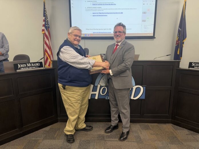 Wisconsin State Rep. David Steffen congratulates Burt McIntyre as he is retiring from his honorable decades of service to the Village of Howard.