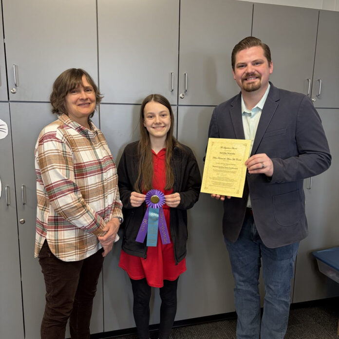 Wisconsin State Rep. Nate Gustafson visited Oshkosh Lourdes Academy Middle School to present an award to Aurelia for the Helen Farnsworth Mears Art Contest.